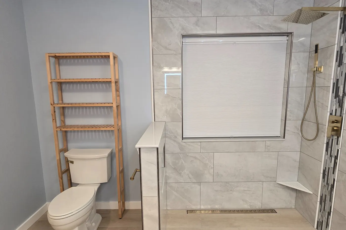 Grey large-format tile with brushed gold fixtures