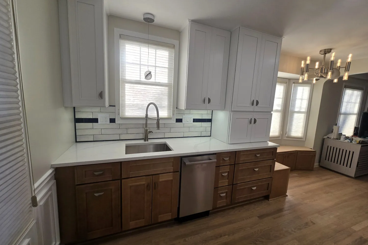 After: the same wall rebuilt with quartz counters and new cabinets