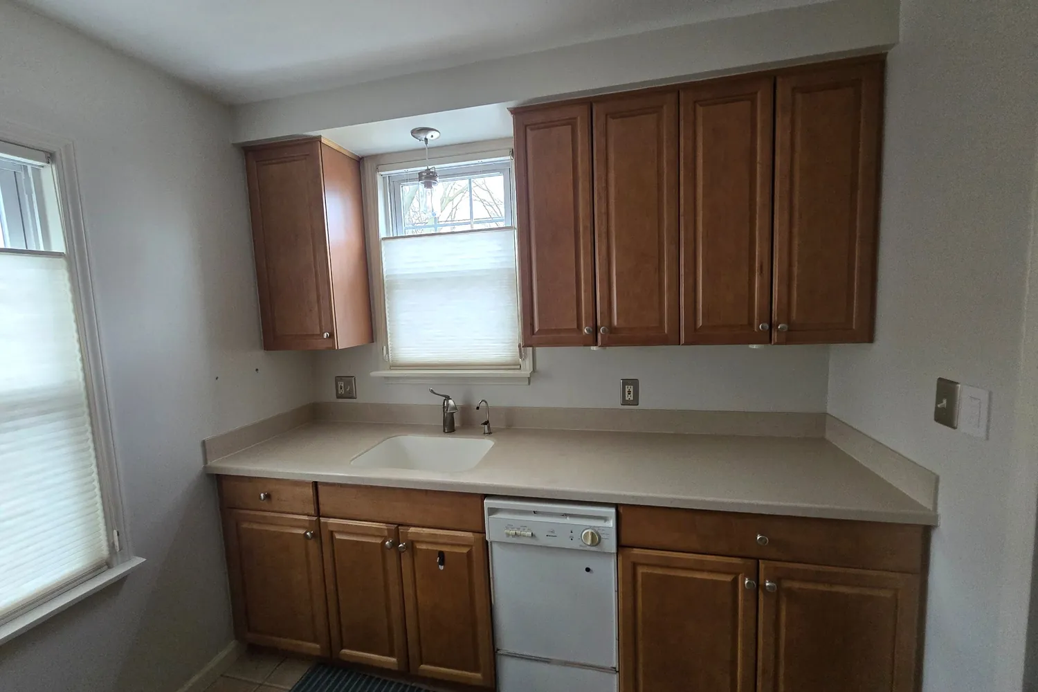 Before: the Plymouth kitchen sink wall with oak cabinets