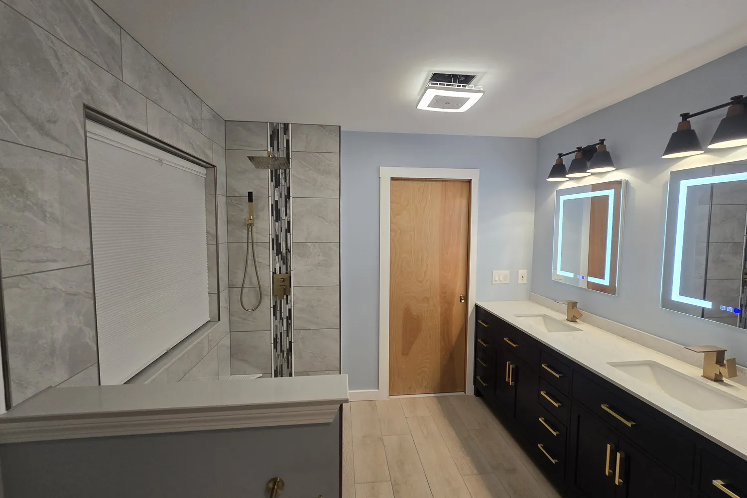 After: the Wixom bathroom with a custom tiled shower and navy vanity