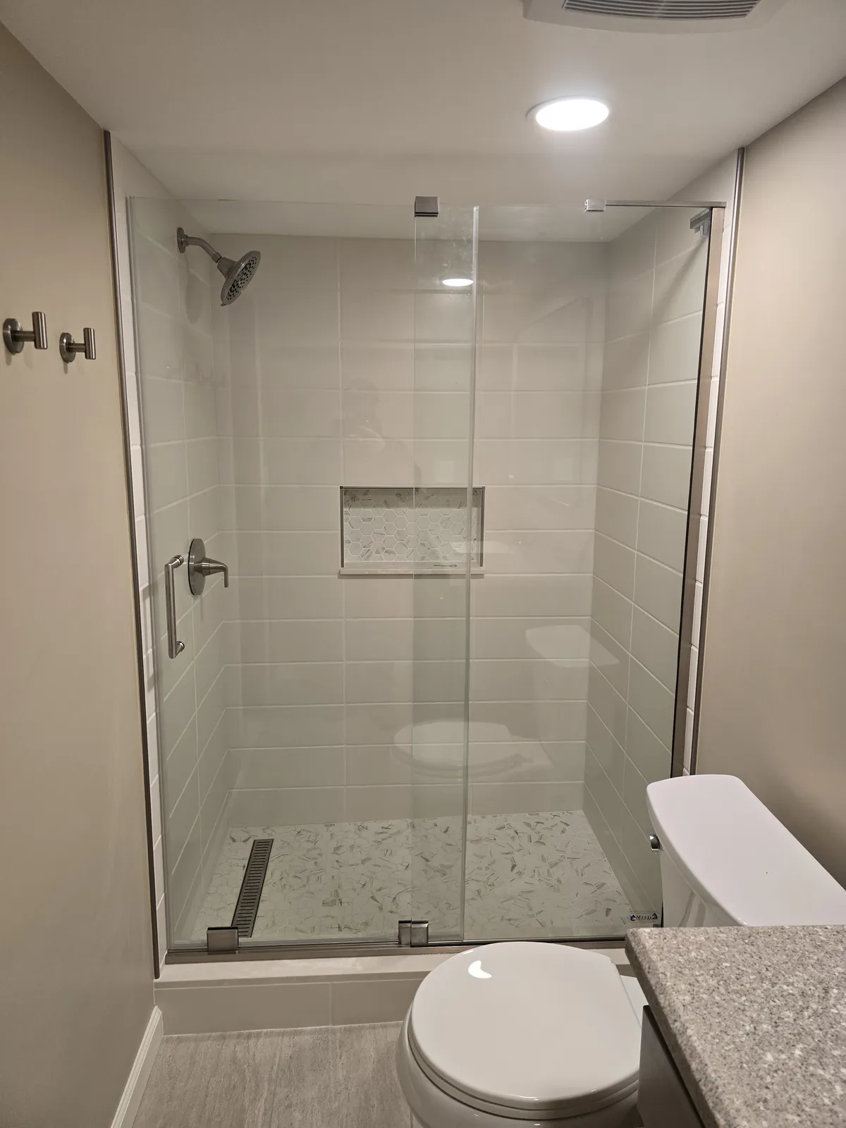 Finished: tiled basement shower with glass door and niche