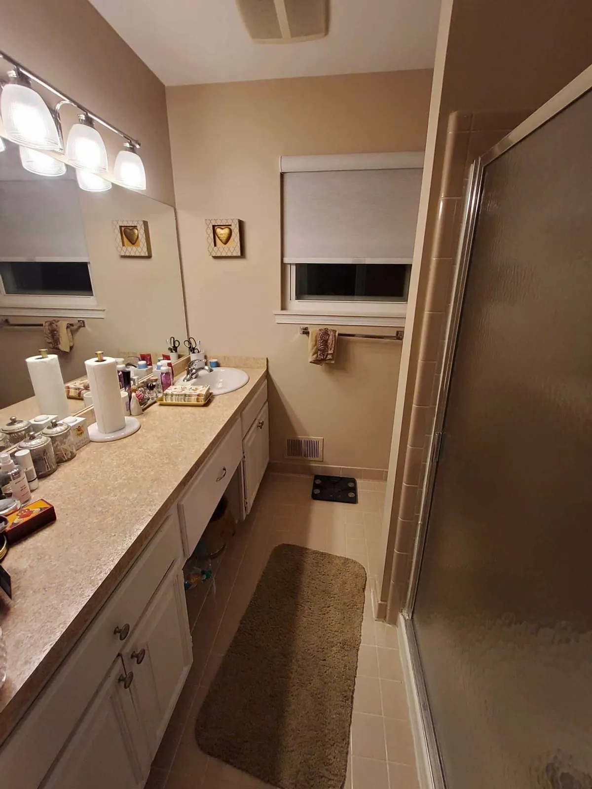 Before: laminate vanity and builder mirror