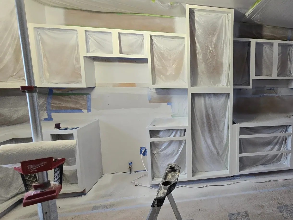 In progress: painted cabinet frames with every opening and surface covered
