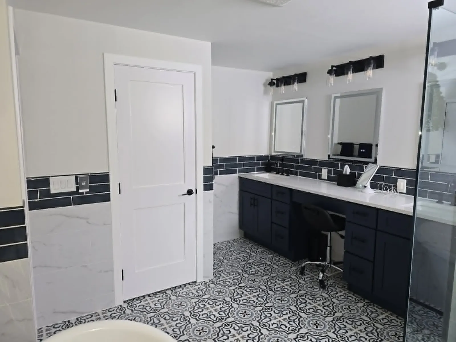 Finished: navy double vanity along the patterned tile floor