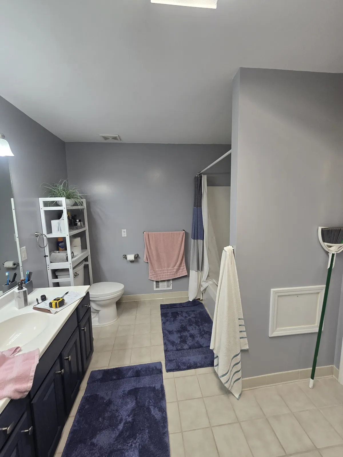 Before: the dated bathroom with tub combo and worn floor