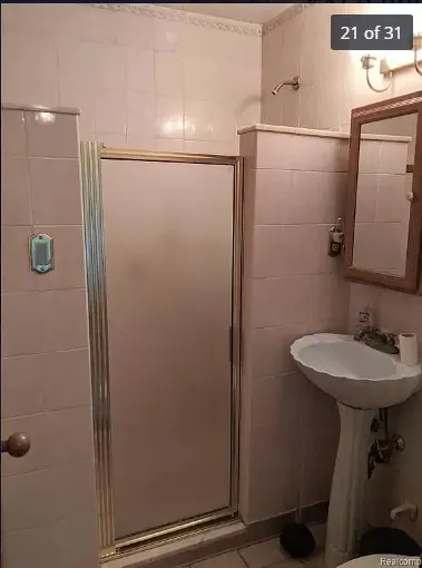 Before: pink tile and the old pedestal sink