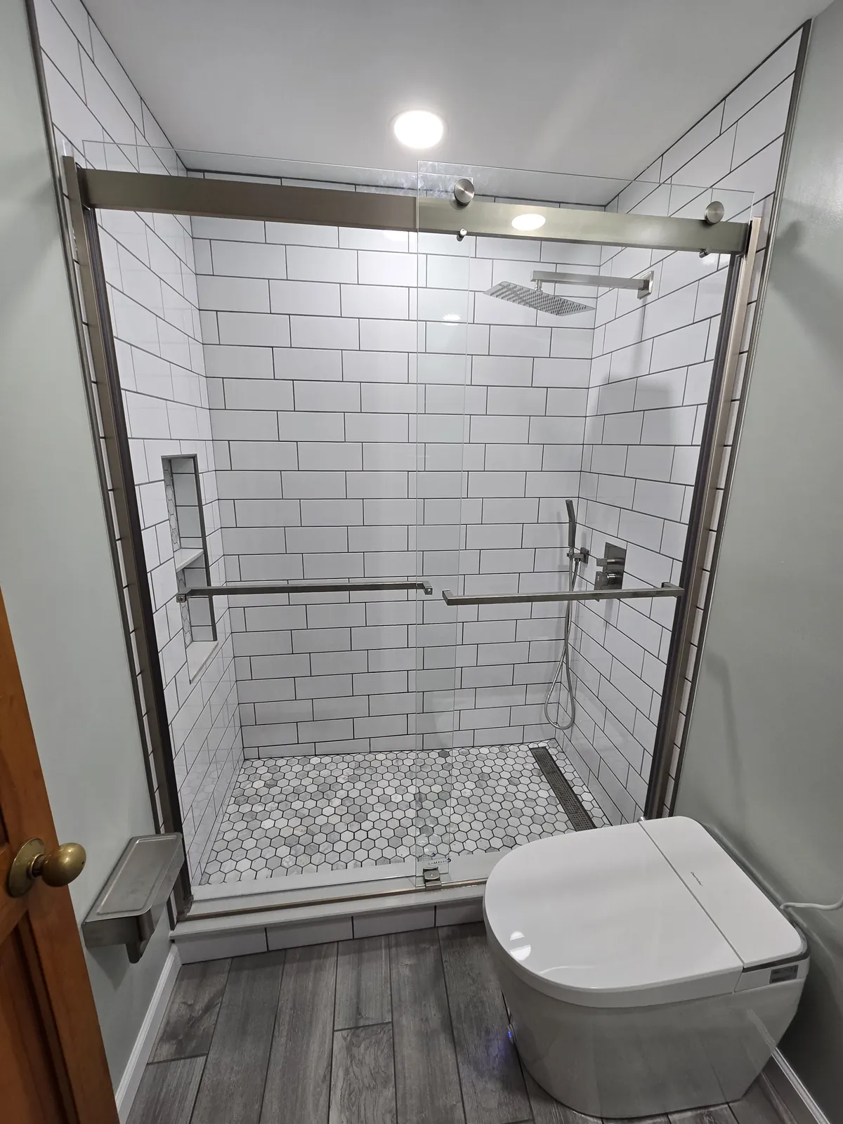 Finished: the subway shower with sliding glass and marble hex floor