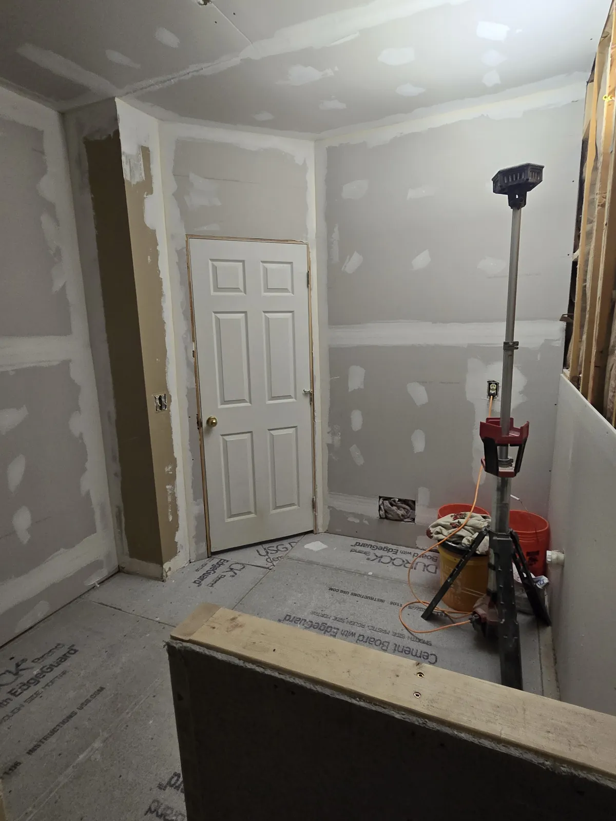 Cement board hung and seams treated, half-wall framed