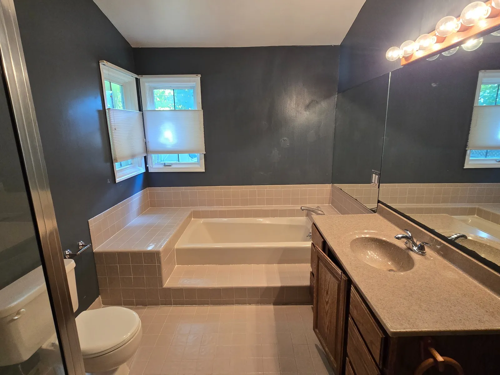 Before: the corner drop-in tub under the windows