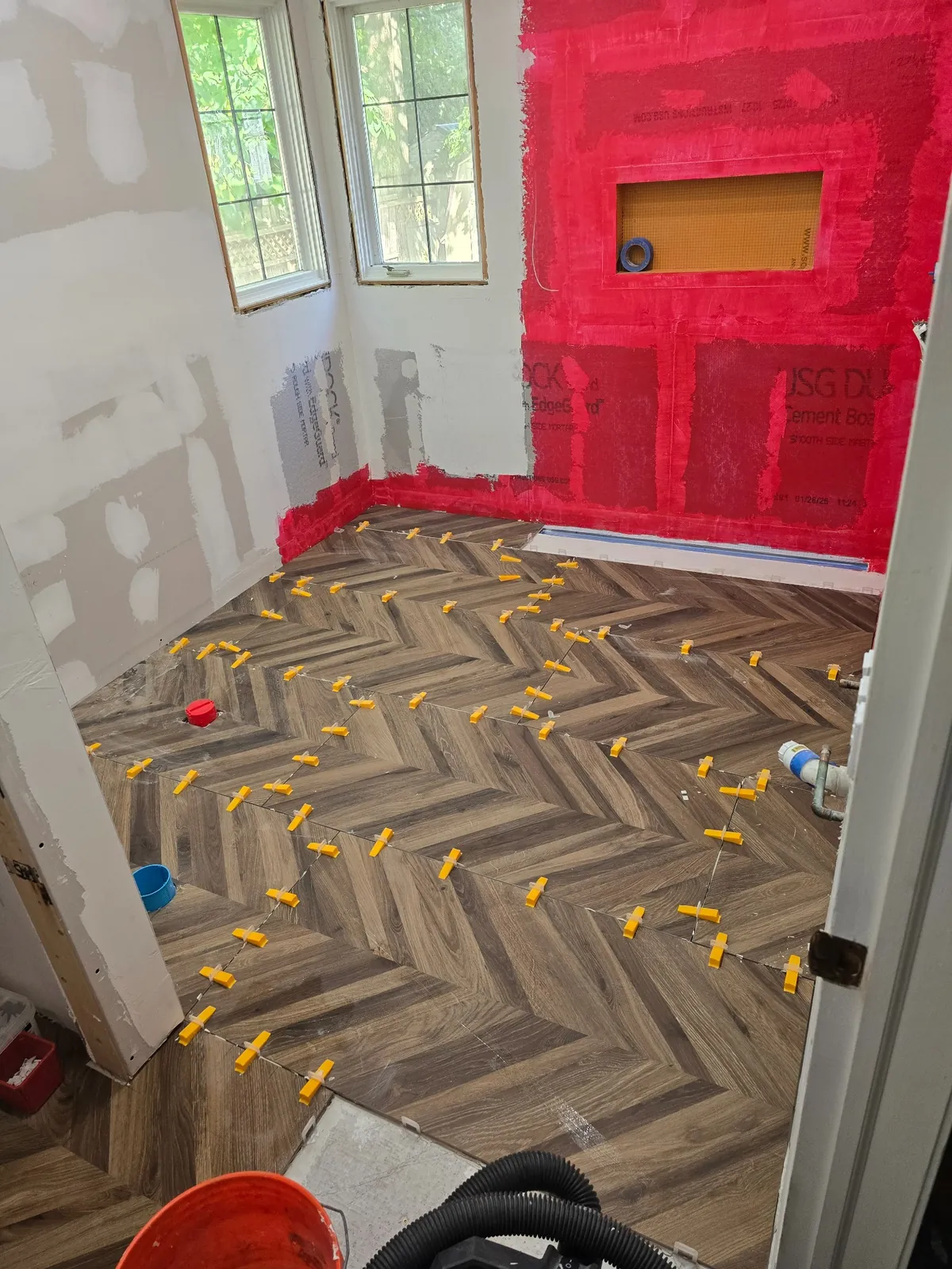 Waterproofing membrane applied over the new herringbone floor before tile