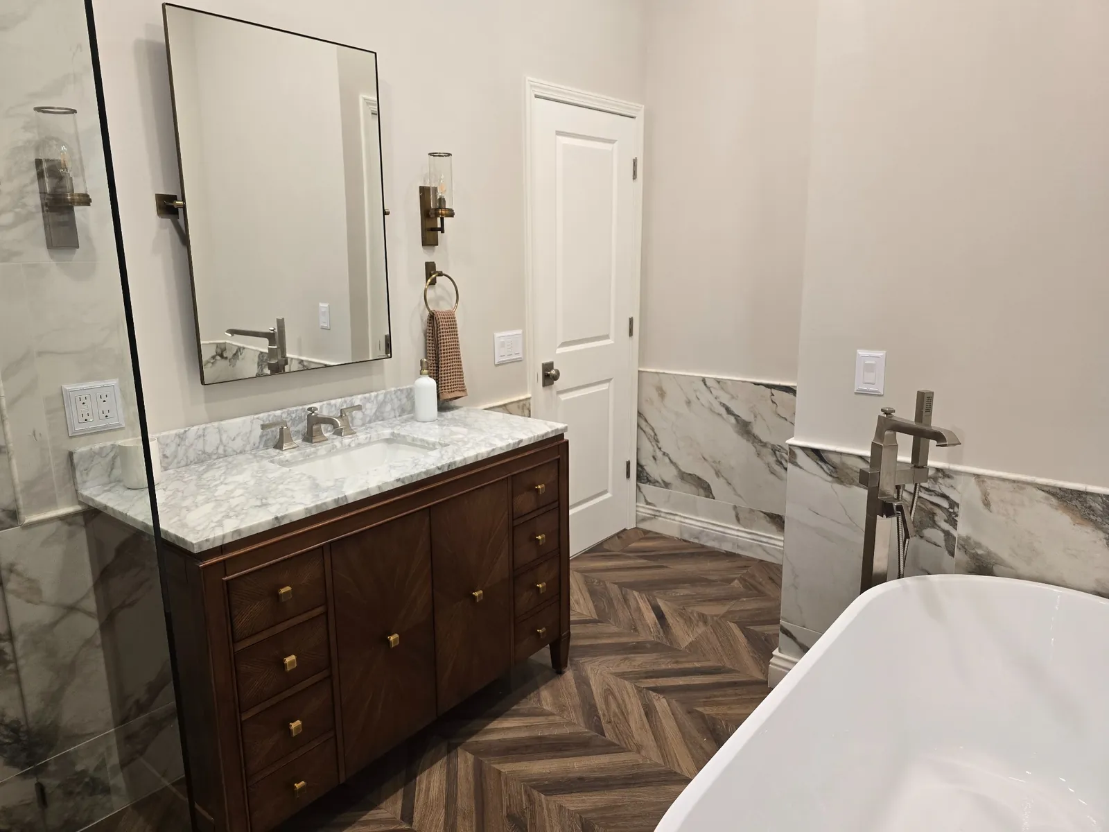 Finished: custom wood vanity with marble top and framed mirror