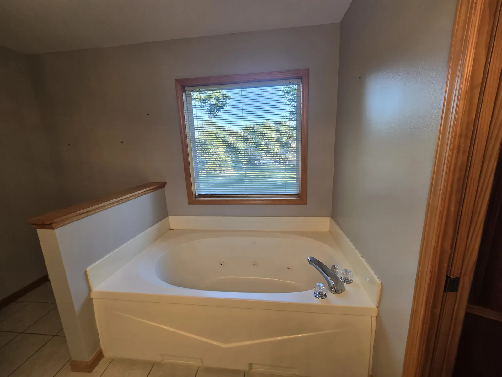 Before: the corner garden tub under the window that the homeowners wanted gone