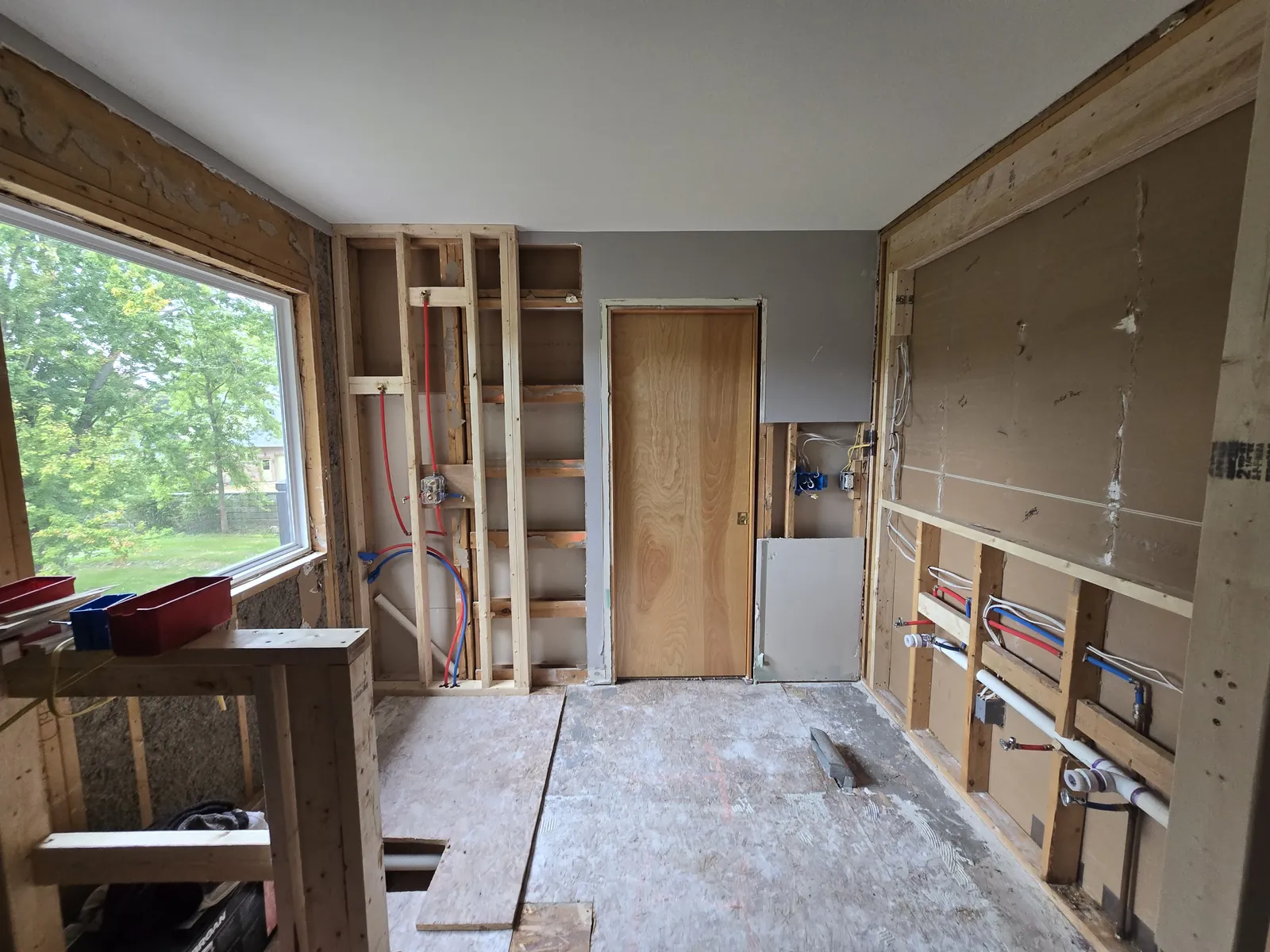 Demo underway: walls opened and plumbing rerouted for the new walk-in shower