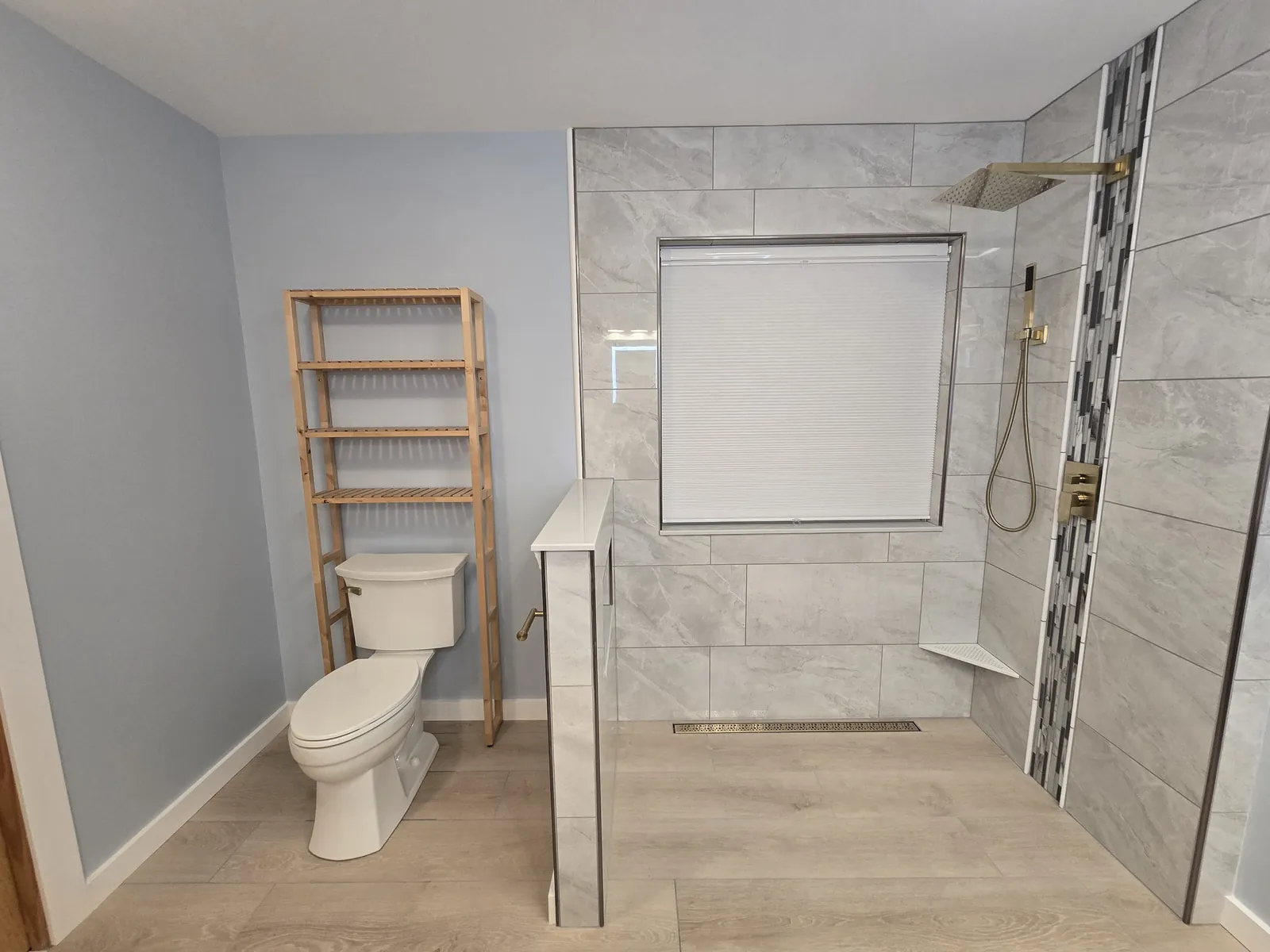 Finished walk-in tiled shower with storage ladder and new toilet