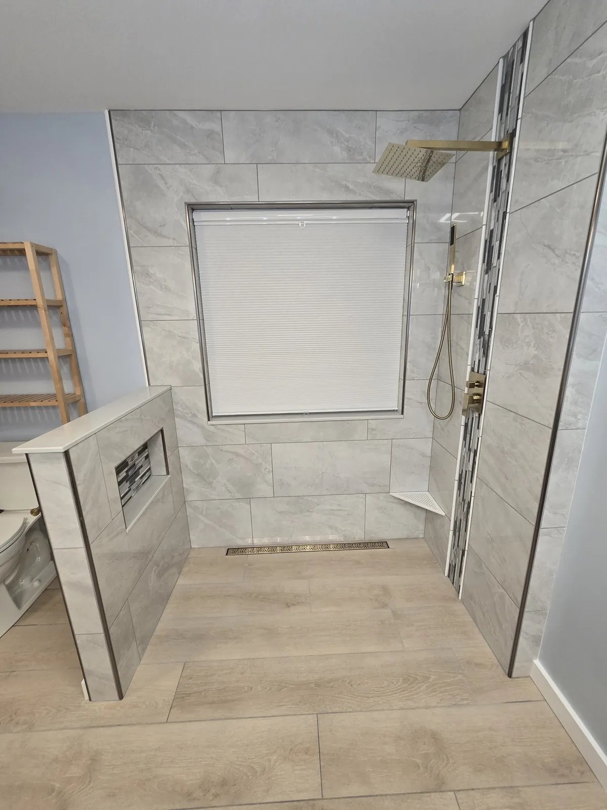 Finished custom shower: full-height tile, mosaic accent band and gold rain shower